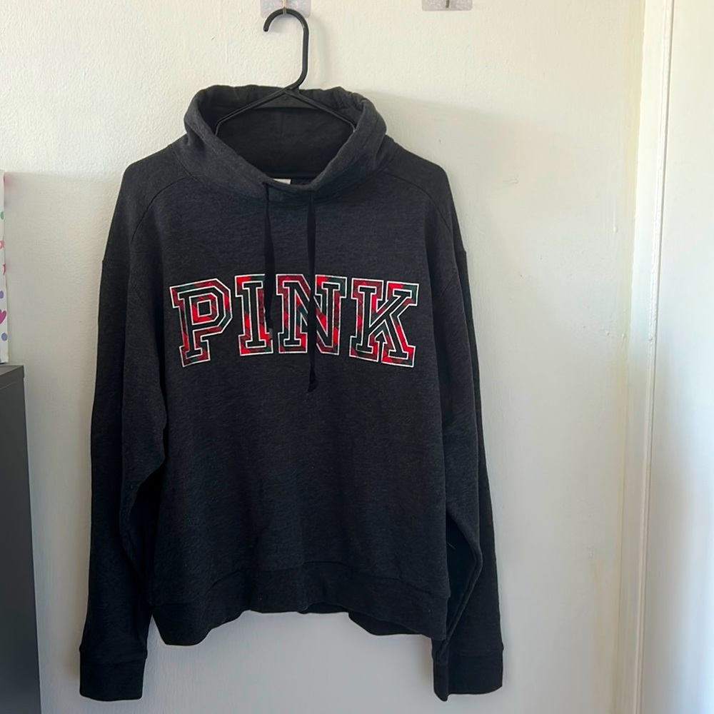 PINK: Dark gray sweater.